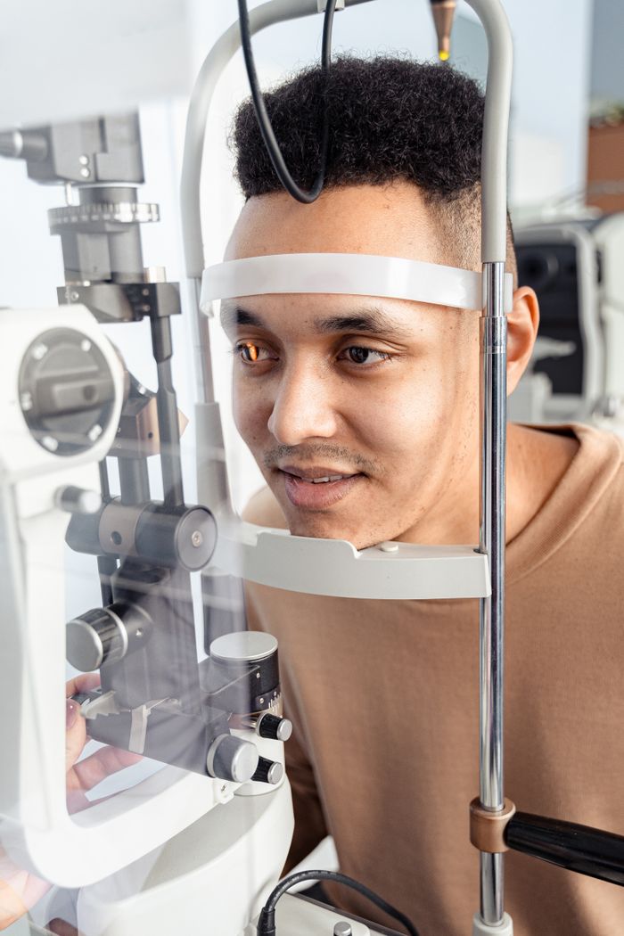 A man getting his eyes examined using modern ophthalmology equipment indoors.